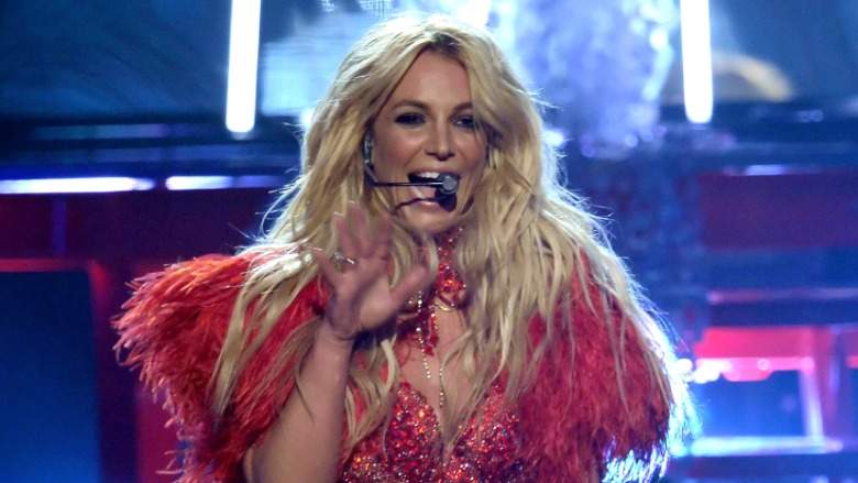 Britney Spears in a red costume on stage in Las Vegas.