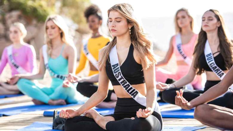 Contestants enjoy a relaxing morning of yoga at Dekel Beach.