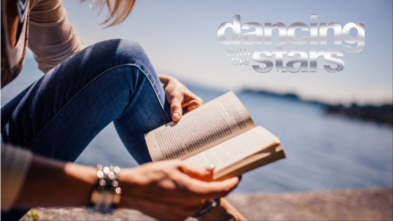 A woman holding a book.