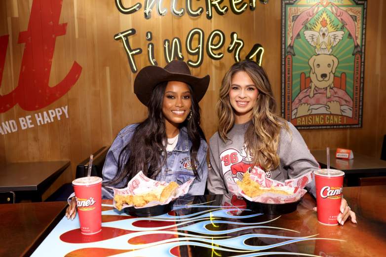 Ciara Miller and Kelsey Anderson smile in front of their Raising Cane's meals.