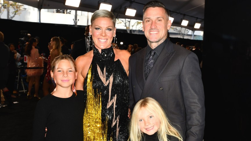 Carey Hart and Pink smiling with their children