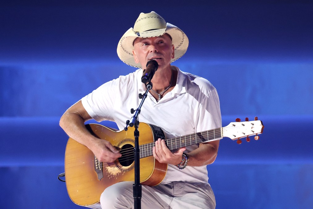 Kenny Chesney singing and playing guitar
