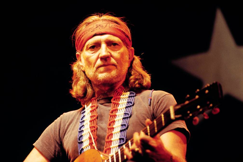Willie Nelson holding a guitar