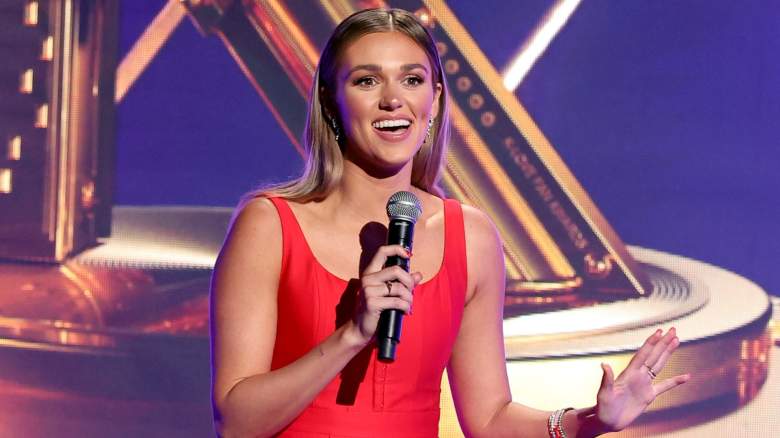 Sadie Robertson smiling and holding microphone