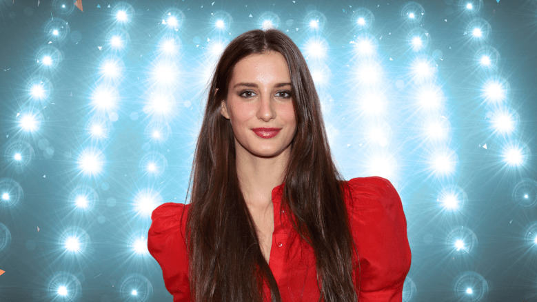 Audrey McGraw posing in front of colorful lights.
