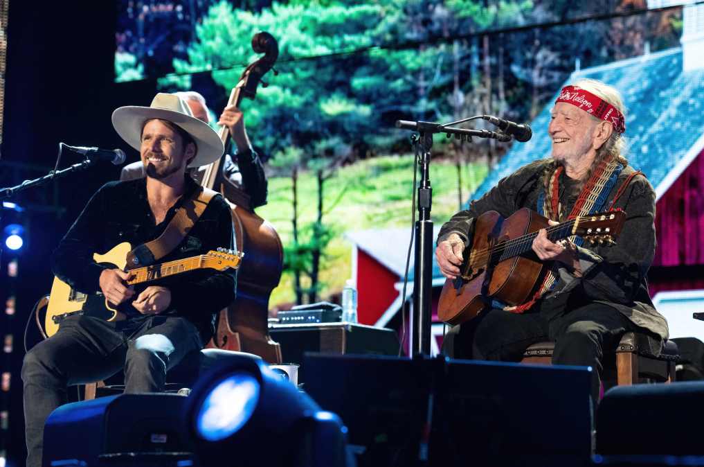 Lukas Nelson and Willie Nelson performing on stage together