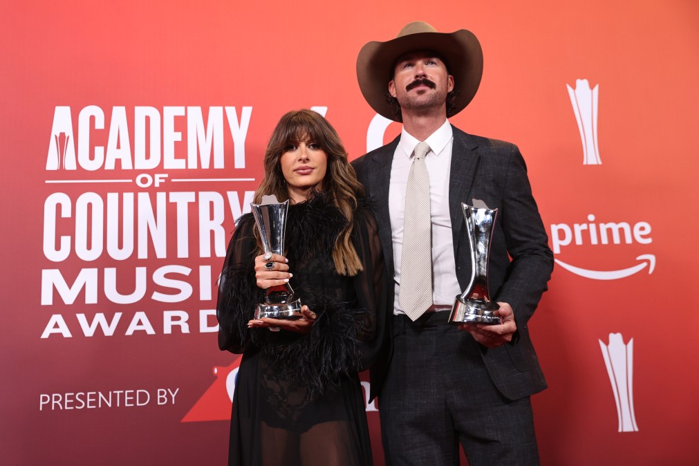 Ella Langley and Riley Green pose with ACM Awards.