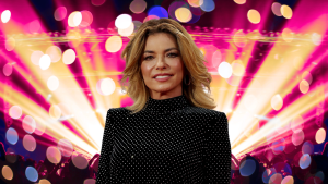 Shania Twain posing in front of colorful lights