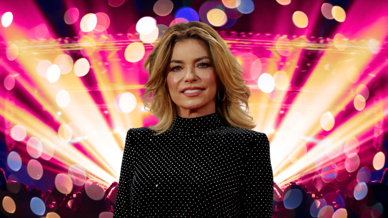 Shania Twain posing in front of colorful lights