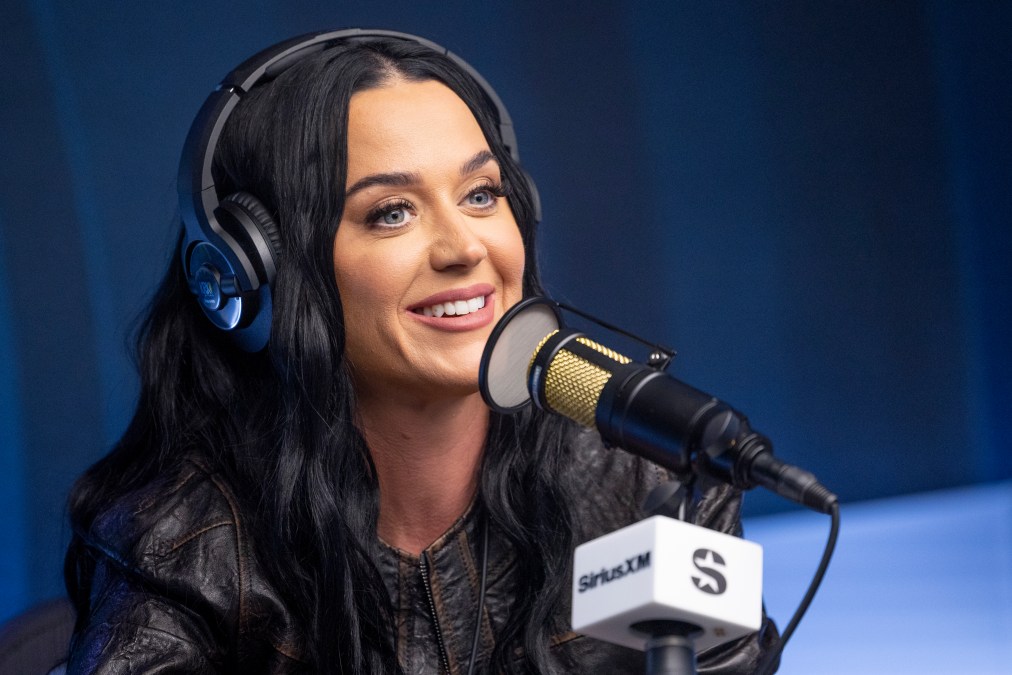 Katy Perry sitting behind a microphone