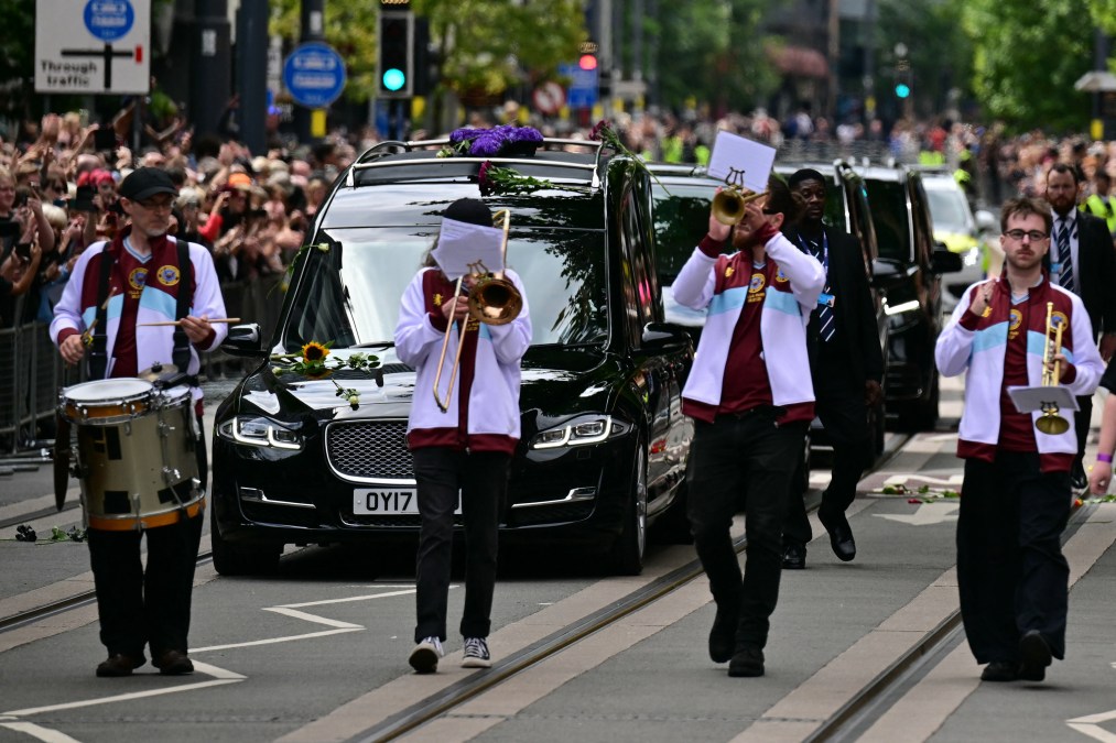 Mourners and music fans line the streets to pay their respects 
