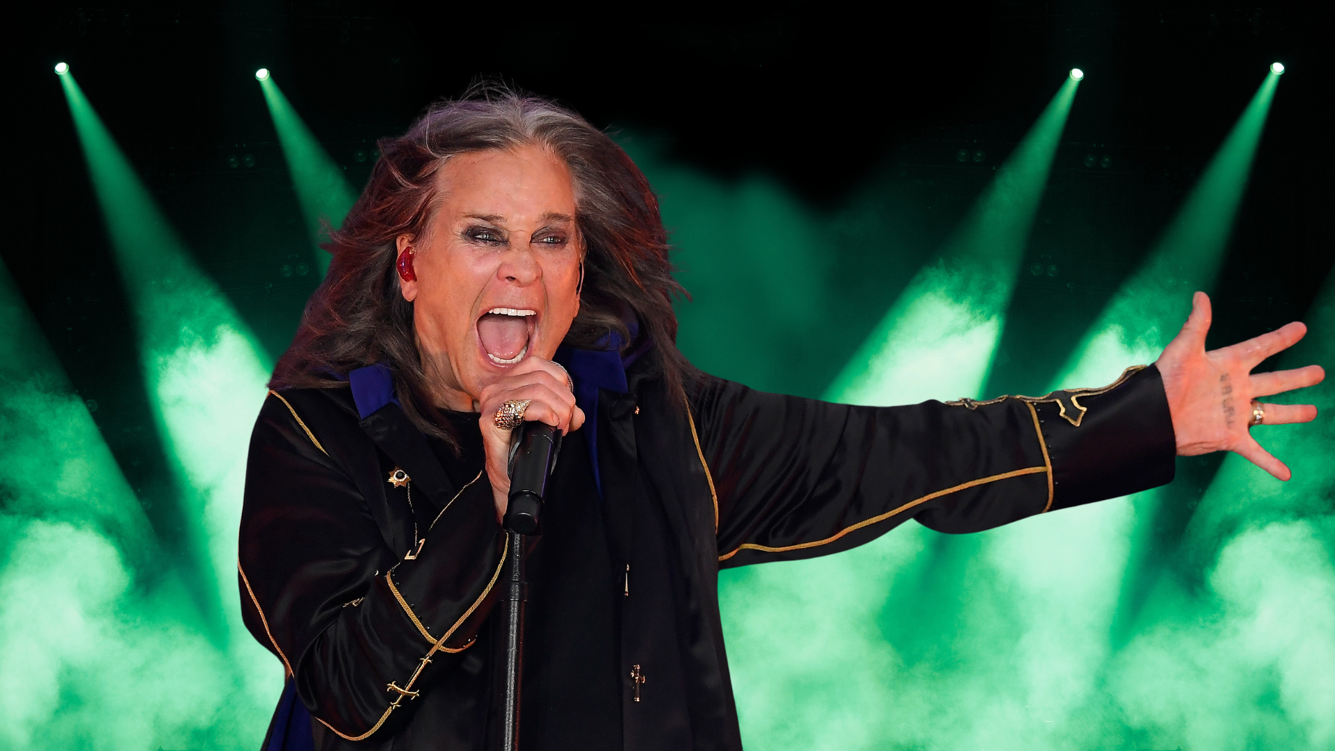 Ozzy Osbourne singing on stage.