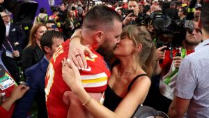 Travis Kelce #87 of the Kansas City Chiefs and Taylor Swift embrace after defeating the San Francisco 49ers in overtime during Super Bowl LVIII