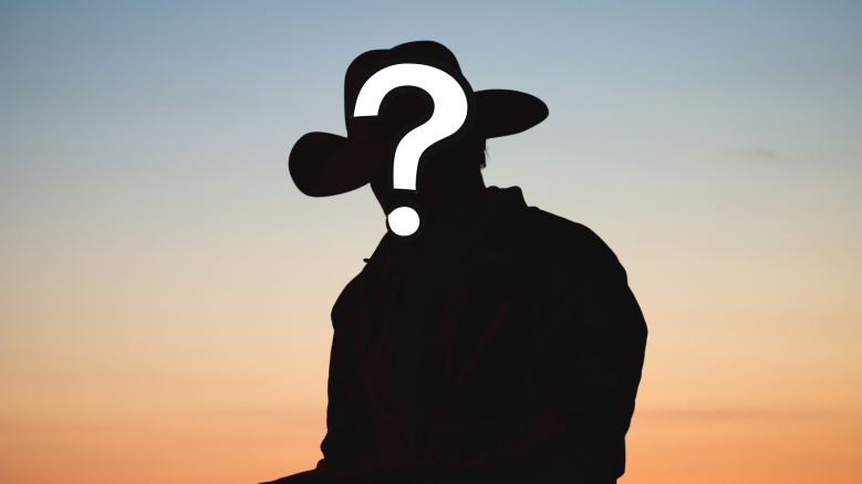 A silhouette of a cowboy against a sunset