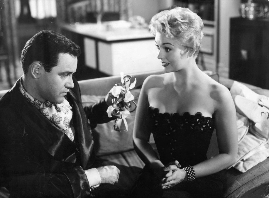 Jack Lemmon on couch with Kim Novak in a scene from the film 'Phffft', 1954.