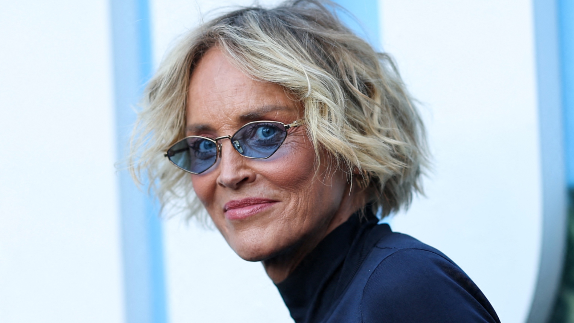 Sharon Stone wearing sunglasses at an event