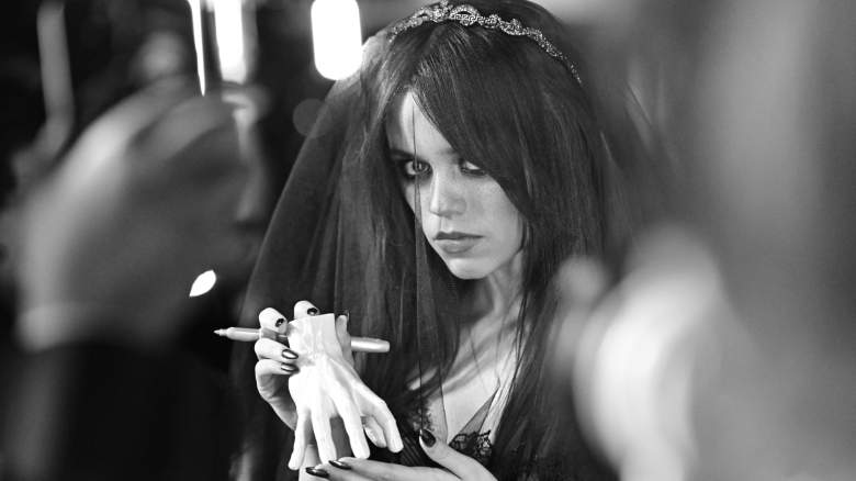 Jenna Ortega poses for photos with a black veil.