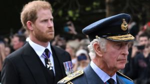 Britain's King Charles III and Britain's Prince Harry, Duke of Sussex walk behind the coffin of Queen Elizabeth II,