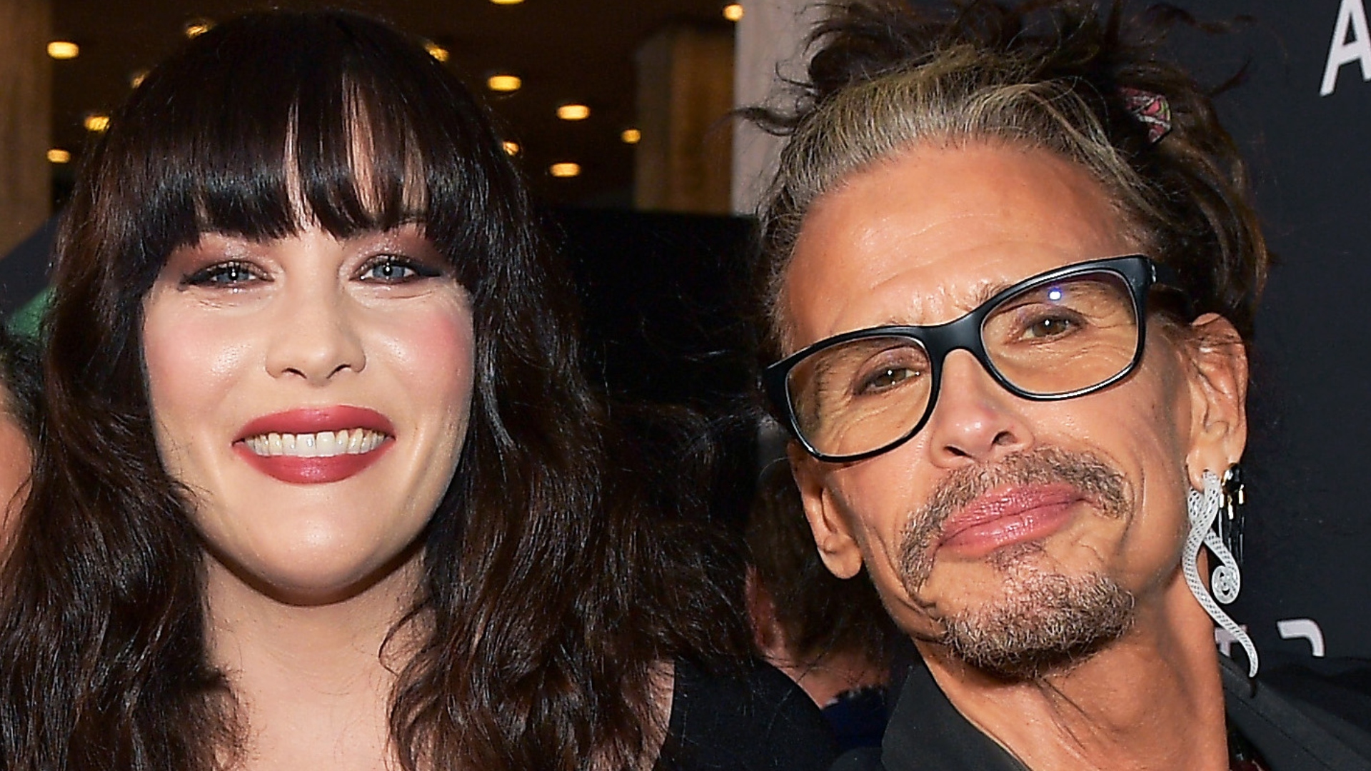Liv Tyler and her father Steven Tyler smiling at an event