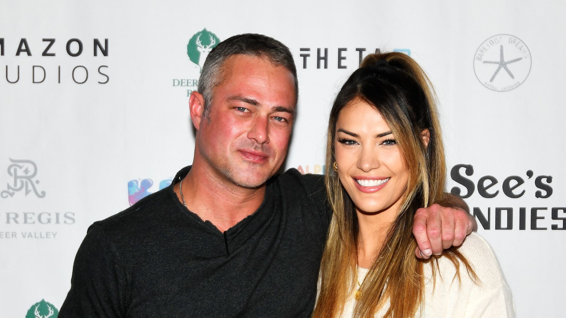 Taylor Kinney (L) and Ashley Cruger attend Operation Smile's 10th Annual Park City Ski Challenge Presented By The St. Regis Deer Valley & Deer Valley Resort at The St. Regis Deer Valley on April 02, 2022 in Park City, Utah