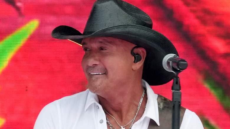 Tim McGraw wearing a stetson hat and performing onstage