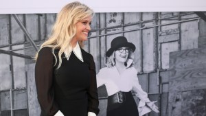 Reese Witherspoon poses infront of a Diane Keaton photo