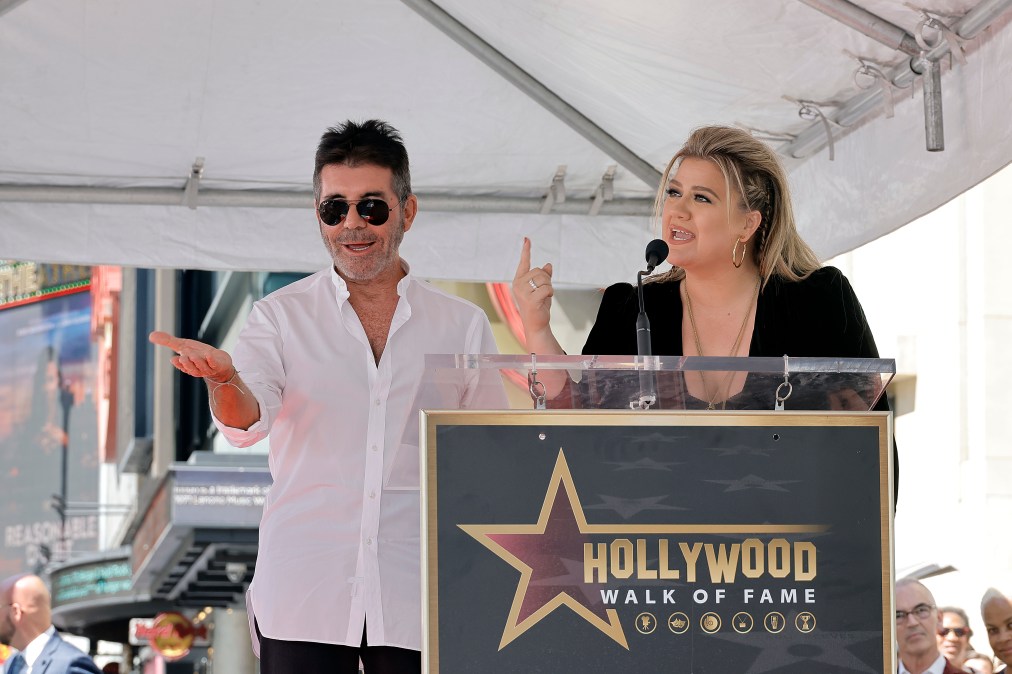 Kelly Clarkson and Simon Cowell attend an award ceremony