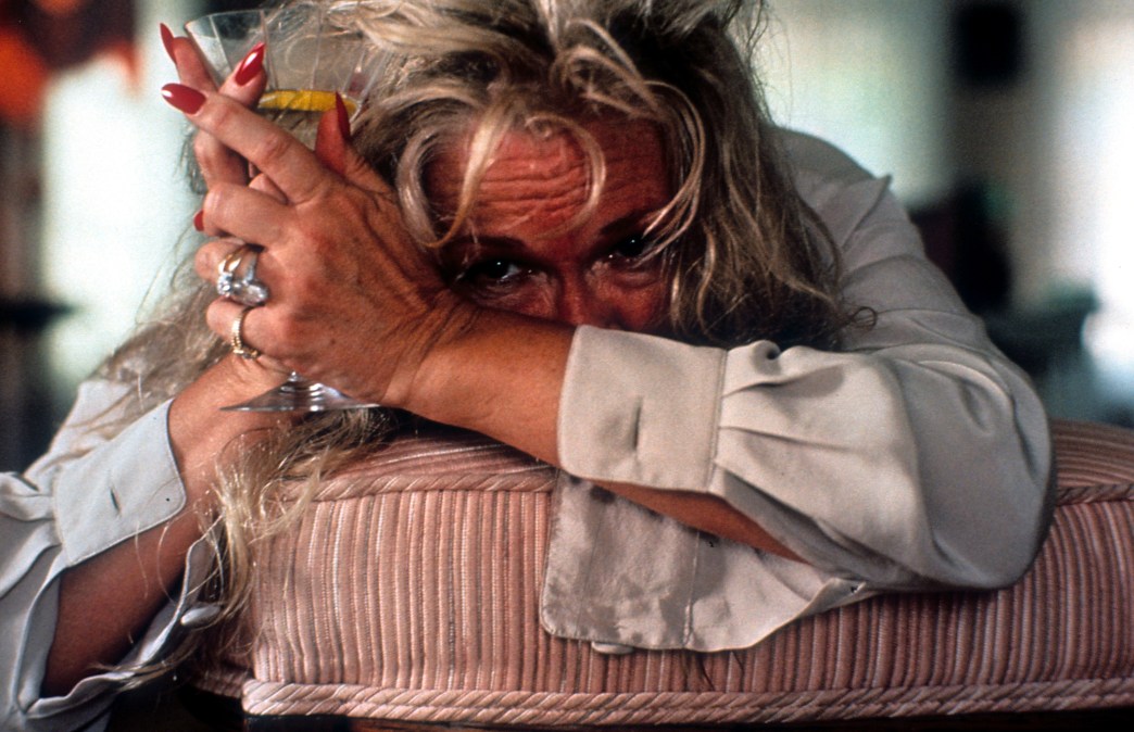 Diane Ladd collapses on a cushion in a scene from the film 'Wild At Heart', 1990