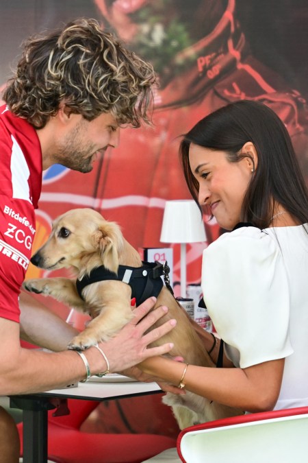 Alexandra Saint Mleux, girlfriend of Ferrari's Monegasque driver Charles Leclerc, holds her dog Leo 