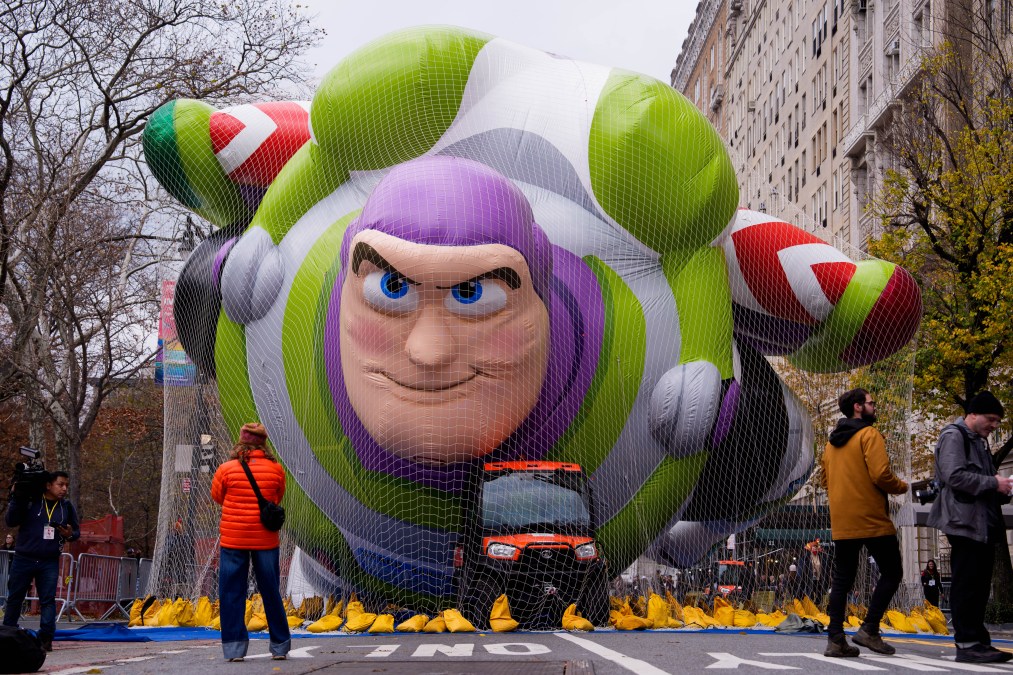 People walk near the new Buzz Lightyear balloon