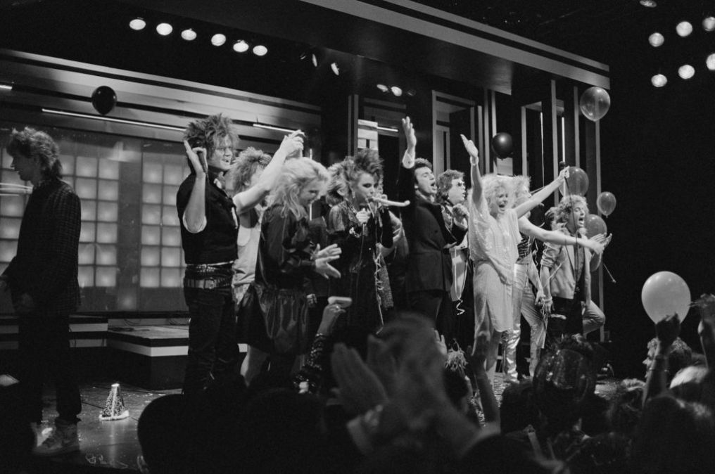 Patty Smyth with her band Scandal, Night Ranger, Ronnie Milsap, Adrian Zmed, and Priscilla Barnes on stage filming TV special "Dick Clark's New Year's Rockin' Eve 1985"