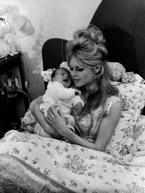French actress Brigitte Bardot holds her baby Nicolas