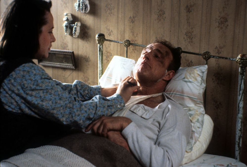 Kathy Bates watches over James Caan in a scene from the film 'Misery', 1990
