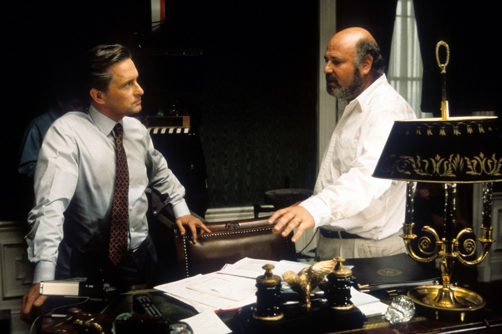 Michael Douglas listening to Director Rob Reiner in between scenes from the film 'The American President', 1995.
