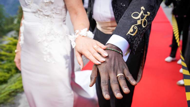 The bride and groom show their rings as thy arrive at their wedding party