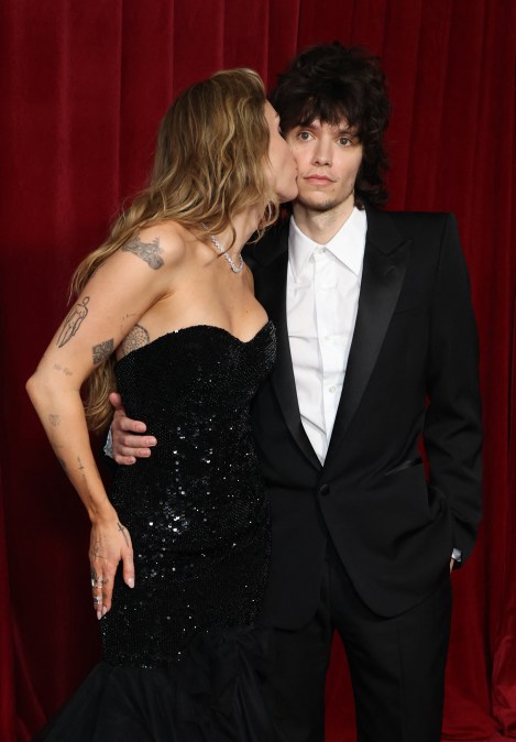 US singer actress Miley Cyrus kisses singer Maxx Morando
