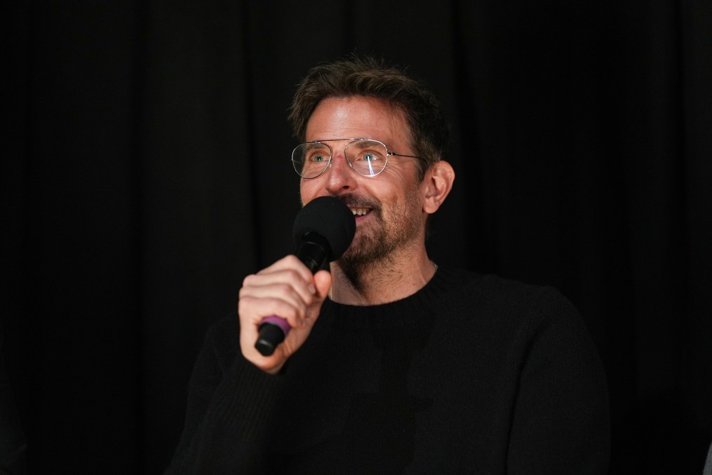 Bradley Cooper speaking into microphone
