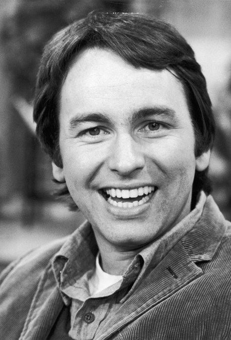 Headshot of American actor John Ritter smiling on the set of the television series, 'Three's Company'.