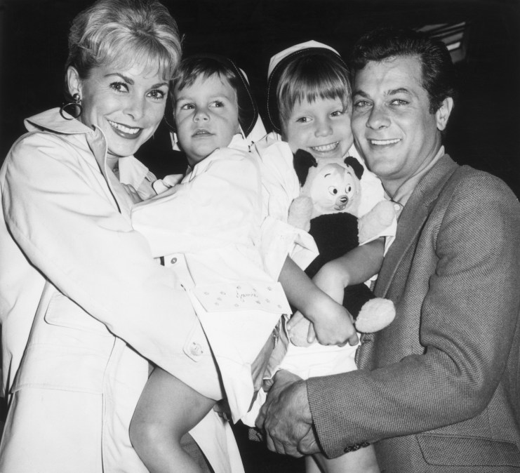 1961: Married American actors Janet Leigh and Tony Curtis holding their daughters Kelly (right), 5, and Jamie, 2,