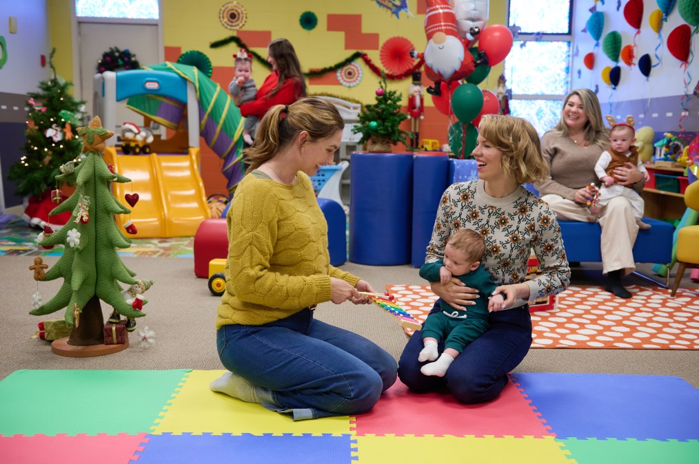 Katherine Barrell, Ali Liebert playing with a baby
