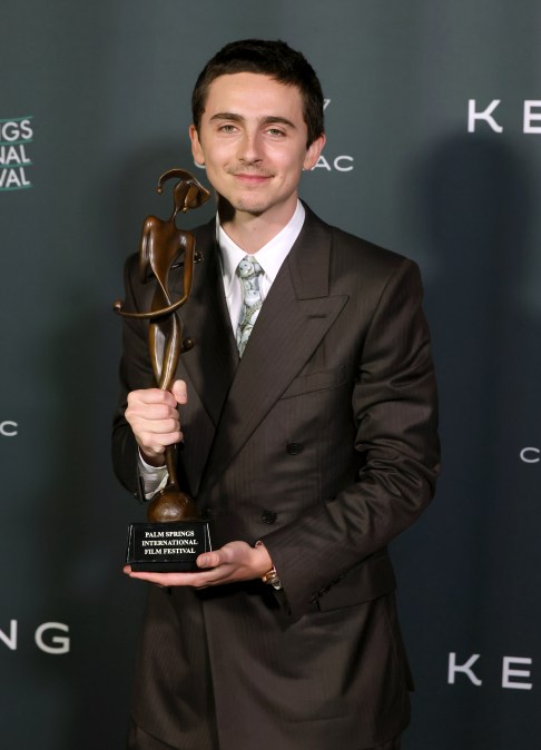 Timoth&eacute;e Chalamet holding a trophy at 37th Annual Palm Springs International Film Festival Film Awards