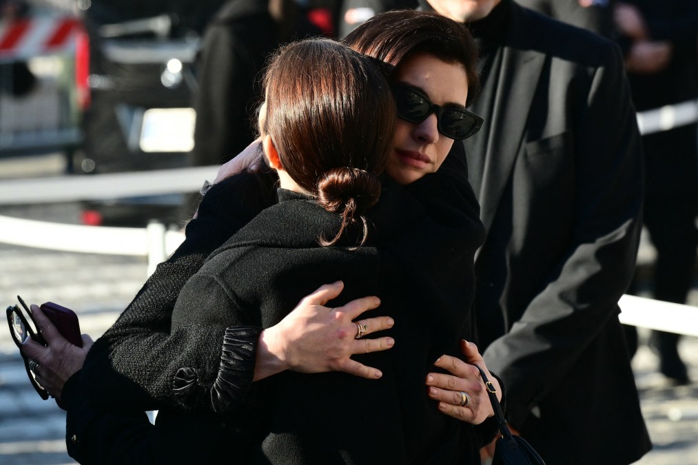 US actress Anne Hathaway (R) arrives at the funeral ceremony for the late Italian fashion designer Valentino Gavarani