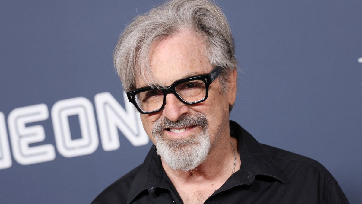 Robert Carradine smiles as he poses for photos at an event