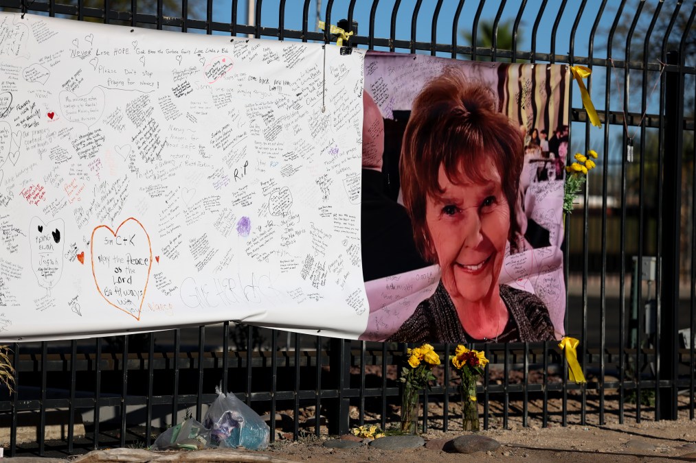 Nancy Guthrie's image on a fence