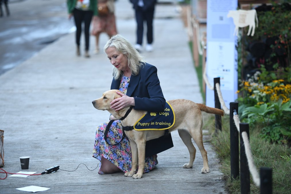 Chelsea Flower Show..Carol Kirkwood On The Ground Chasing A Blind Dog During Filming Today ....Evening Standard Picture.