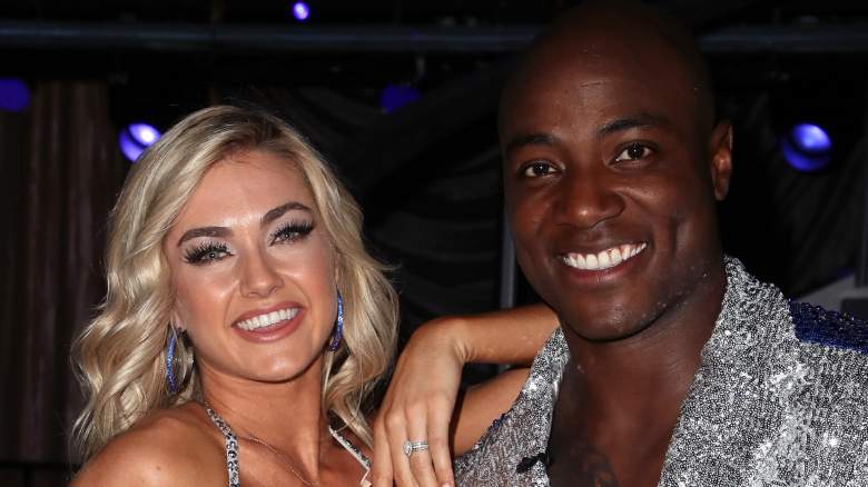 Lindsay Arnold leans on DeMarcus Ware's shoulder in matching silver dance costumes.